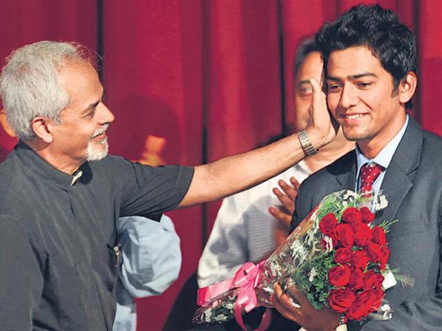 St-Stephen-s-college-principal-Valson-Thampu-felicitates-under-19-cricket-captain-Unmukt-Chand-on-Tuesday-Raj-k-Raj-HT-photo