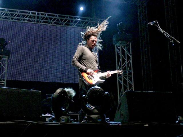 Band member James 'Munky' Shaffer performs with his guitar during the concert. The band played some of their popular numbers such as Narcissistic Cannibal, Freak on a Leash, Get Up, Blind among others.
