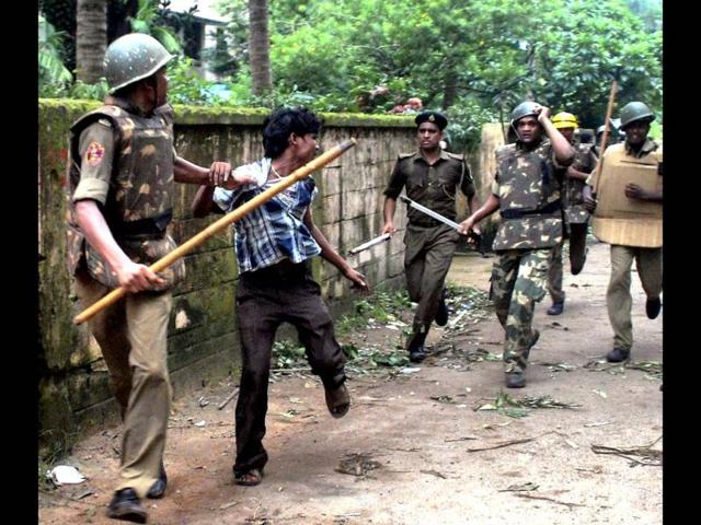 Policemen charge a Congress worker during a clash after a protest over coal blocks allocation in Bhubaneswar. (PTI photo)