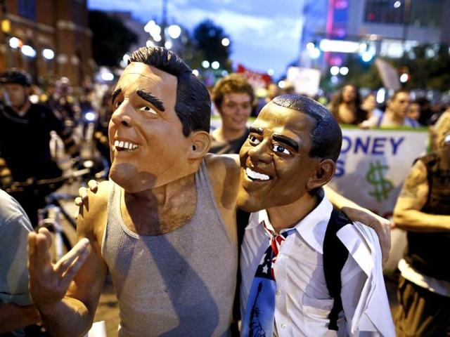 Demonstrators wear masks of US Republican presidential candidate Mitt Romney and US President Barack Obama at a march during the final day of the Democratic National Convention in Charlotte, North Carolina. Reuters/John Adkisson