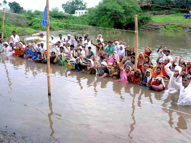 Omkarsershwar Dam affected people continuously standing in the back water of Narmada river in protest for rehabilitation, organised by Narmada Bachao Andolan activists at Gogalgaon in Khandwa District, Madhya Pradesh. AP Photo
