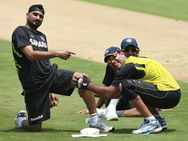 Harbhajan Singh gestures to teammate Yuvraj Singh who holds his leg during a training session ahead of their first Twenty20 cricket match against New Zealand in Visakhapatman. AP Photo