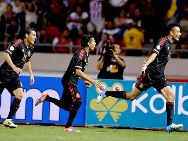 Mexico's Jesus Zavala celebrates with teammates Hector Moreno and Javier Aquino after scoring against Costa Rica during their Brazil 2014 FIFA World Cup 2014 qualifier football match held at the National Stadium in San Jose. AFP/Ezequiel Becerra
