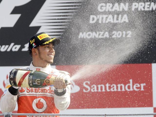McLaren Mercedes driver Lewis Hamilton, of Britain, celebrates after winning the Italian Formula One GP, at the Monza racetrack, in Monza, Italy. AP Photo/Antonio Calanni