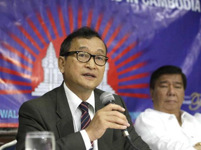 Cambodian opposition leader Sam Rainsy, left, who is currently living in exile in France, talks about the opposition's plans for next year's elections in Cambodia during the launching of the International Parliamentary Committee for Democratic Elections in Cambodia with Philippine Sen. Franklin Drilon. (AP Photo/Bullit Marquez)
