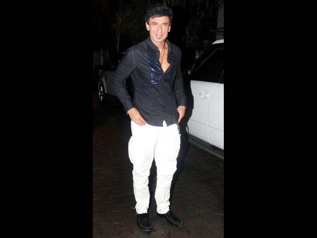 Mukul Dev is clad in a black shirt over white pants.