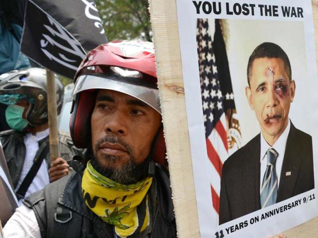 Indonesian protesters from a group called "Sharia For Indonesia" hold up placards showing US President Barack Obama as they attend a demonstration against the US government to mark the anniversary of the 9/11 attacks, outside the US embassy in Jakarta. AFP