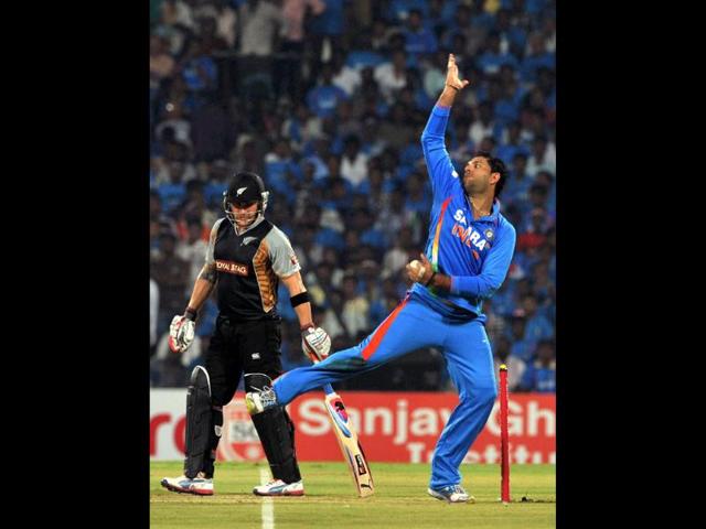 Yuvraj Singh bowls a delivery while New Zealand batsman Brendon McCullum looks on during the second T20 match between India and New Zealand at the MA Chidambaram Stadium in Chennai. AFP/Manjunath Kiran