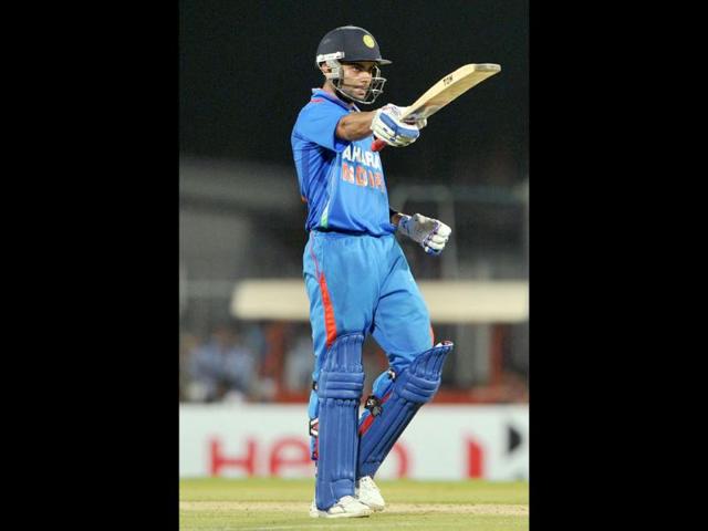 Virat Kohli raises his bat after scoring 50 runs during the second T20 match between India and New Zealand at the MA Chidambaram Stadium in Chennai. AFP/Manjunath Kiran
