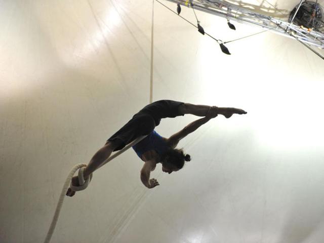Svitlana Kashevarova, a performer with the world famous troupe Cirque du Soleil, practices her acrobatic routine on a suspended rope at the backstage big top tent in Sydney. (AFP Photo)
