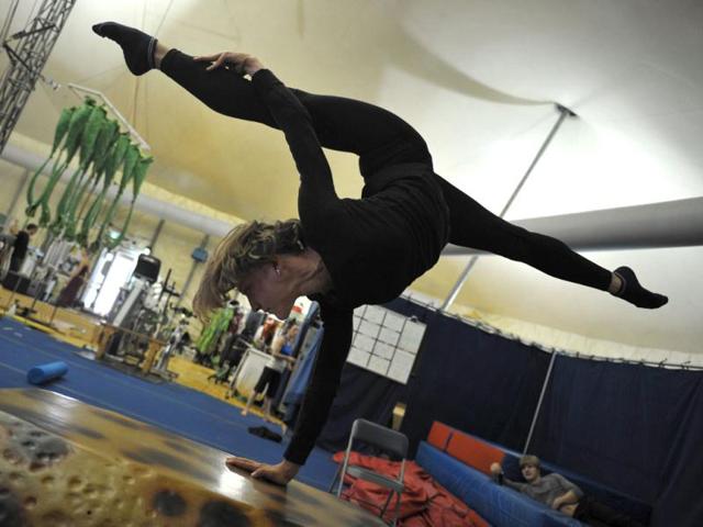 Nadine Louie, a performer of the world famous trouple Cirque du Soleil, practices her acrobatic routine in the backstage area of the big top tent in Sydney. (AFP Photo)