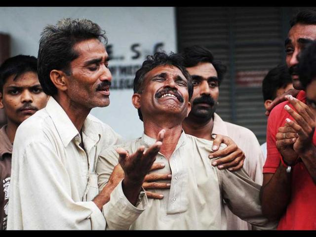 A Pakistani man mourns the death of relatives after a fire erupted in a garment factory in Karachi. (AFP/Asif Hassan)