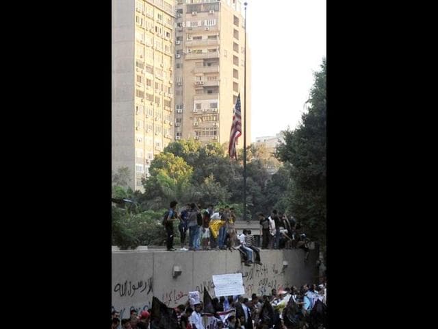 Egyptian protesters bring down the US flag at the US embassy in Cairo during a demonstration against a film deemed offensive to Islam. AFP
