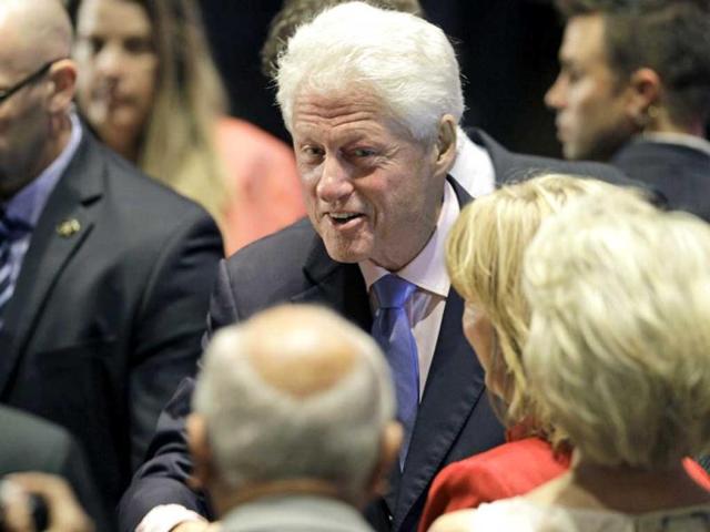 Former US President Bill Clinton greets supporters after speaking at a campaign event in Orlando as he campaigns for President Barack Obama. (AP Photo/John Raoux)