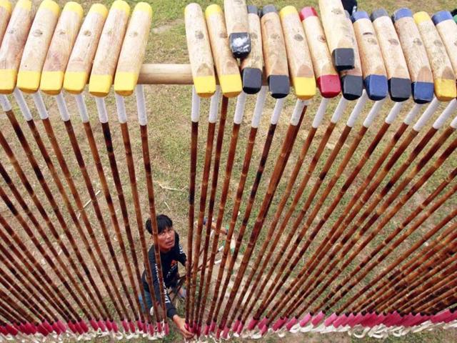 A mahout checks polo mallets before a match during the 11th King's Cup Elephant Polo Tournament in the resort town of Hua-Hin, some 160 km (99 miles) south of Bangkok. Reuters photo/Sukree Sukplang
