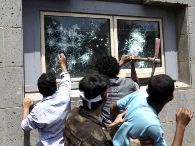 Protesters break windows at the US embassy in Sanaa. Hundreds of Yemeni demonstrators stormed the US embassy in Sanaa in protest against a film they consider blasphemous to Islam, and security guards tried to hold them off by firing into the air.REUTERS
