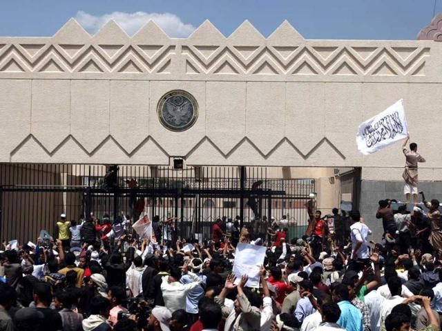Yemeni protesters try to break through the gate of the US embassy in Sanaa during a protest over a film mocking Islam. Yemeni forces managed to drive out angry protesters who stormed the embassy in the Yemeni capital with police firing warning shots to disperse thousands of people as they approached the main gate of the mission. AFP PHOTO/MOHAMMED HUWAIS