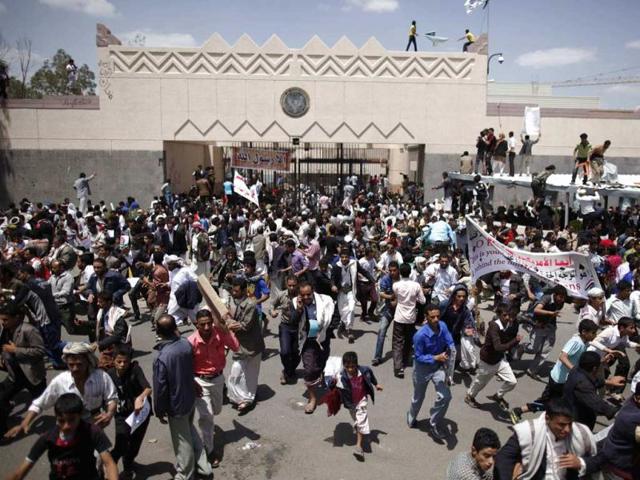 Protesters flee as police open fire into the air to disperse them outside the US embassy in Sanaa. Reuters/Khaled Abdullah