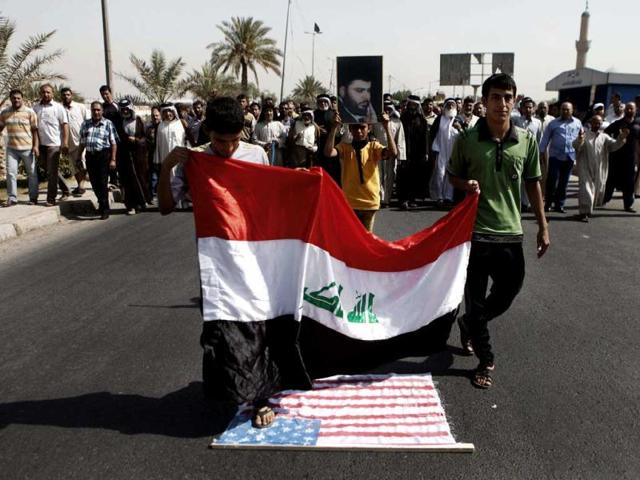 Followers of Shiite cleric Muqtada al-Sadr chant anti-US slogans and step over the US flag during a demonstration as part of widespread anger across the Muslim world about a film ridiculing Islam's Prophet Muhammad, in Baghdad. AP/Karim Kadim