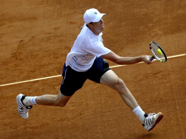 US Sam Querrey returns a ball to Spain's David Ferrer during the first match of the Davis Cup semi-final Spain vs USA at the Hermanos Castro park court in Gijon, northern Spain, on September 14, 2012. AFP Photo