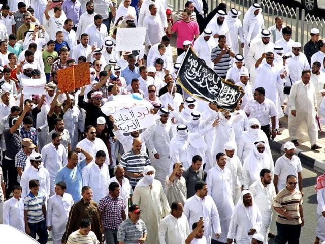 Protesters-carry-posters-and-a-flag-with-Arabic-that-reads-No-God-but-Allah-and-Mohammed-is-his-prophet-and-chant-anti-US-slogans-during-a-peaceful-demonstration-in-front-of-the-US-embassy-in-Doha-Qatar-as-part-of-widespread-anger-across-the-Muslim-world-about-a-film-ridiculing-Islam-s-Prophet-Muhammad-AP-Photo-Osama-Faisal