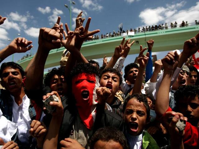Yemeni protesters shout slogans during a demonstration at a street leading to the US embassy in Sanaa against a film mocking Islam. (AFP photo/Mohammed Huwais)