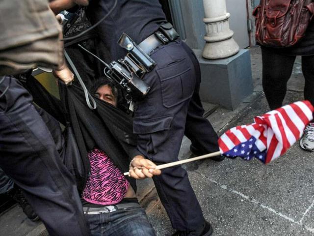 A person associated with the Occupy movement is arrested on a march down Broadway Street in New York enroute to Zuccotti Park. Monday marks the one year anniversary of the Occupy movement. AP photo