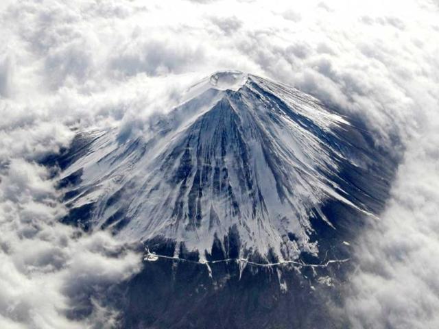 Japan's Mount Fuji, covered with snow and surrounded by cloud, is seen from an airplane in this file photo. Reuters photo