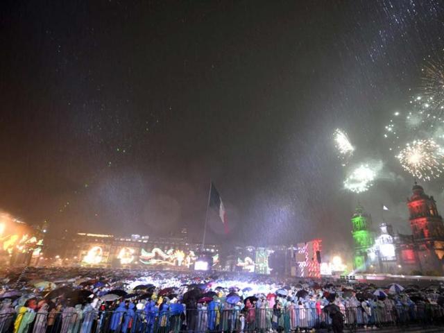 People watch as fireworks light up the sky in Zocalo Square to mark Mexico's Independence Day in Mexico City. Mexicans celebrated their independence from Spanish rule. AFP/Alfredo Estrella