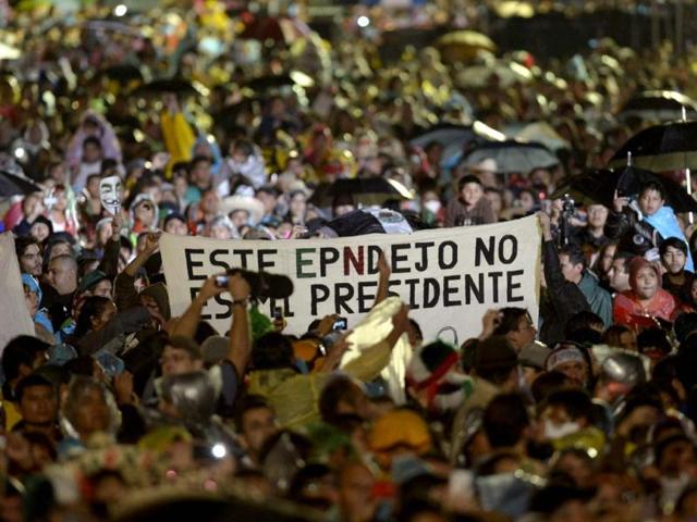Members of the movement called #YoSoy132 protest with a banner during Mexico's Independence Day celebrations at the Zocalo Square in Mexico City. AFP/Alfredo Estrella