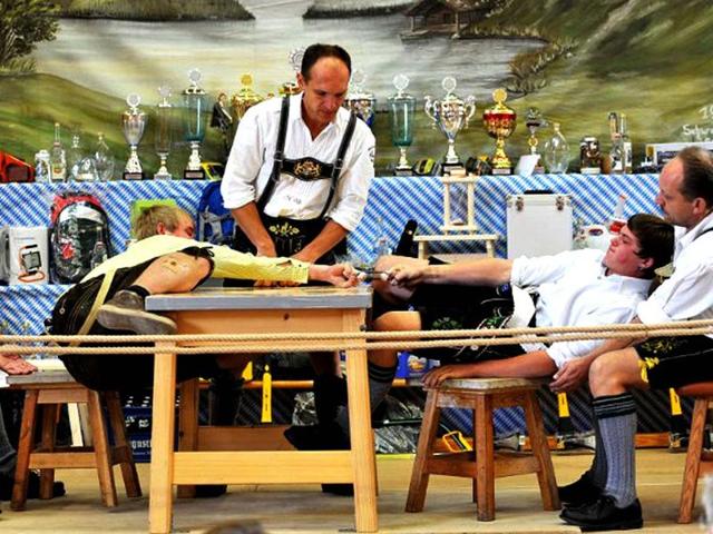 Finger wrestlers compete in the German Finger Wrestling Championship in Warngau, southern Germany. More than 150 men taking part in the traditional Bavarian event try to pull their opponent over the table by using their fingers and a rubber strap only. (AFP photo/ Frank Leonhardt) 