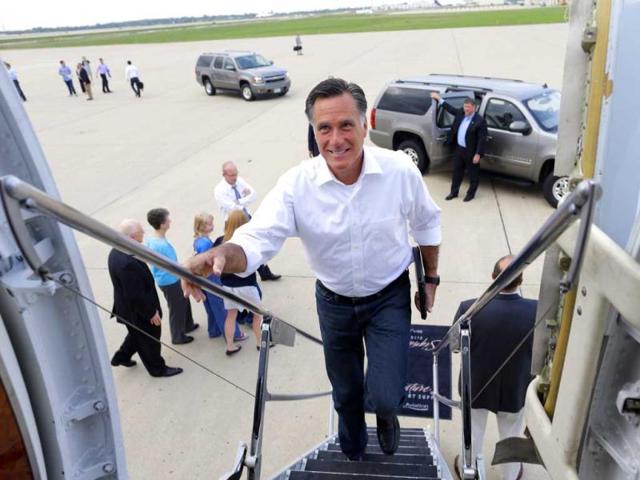 Republican presidential candidate and former Massachusetts Governor Mitt Romney boards his campaign charter plane in Kansas City, after a refueling as he travels to Los Angeles. AP photo