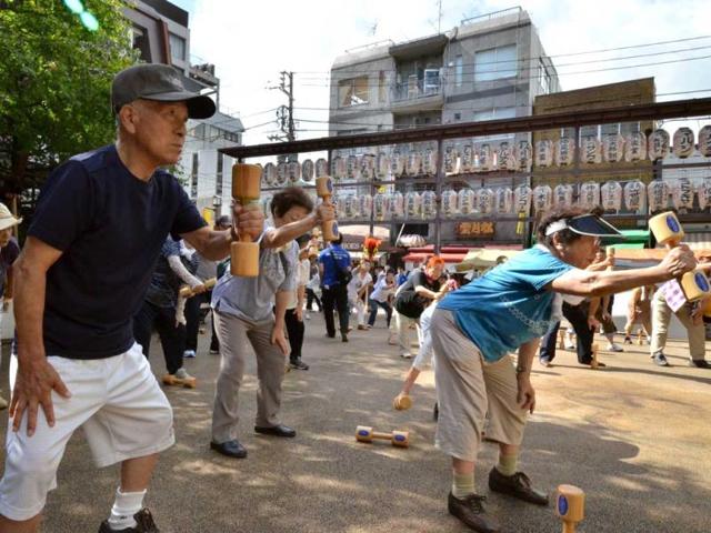 Elderly people work out with wooden dumb-bells in the grounds of a temple in Tokyo to celebrate Japan's Respect-for-the-Aged-Day. The estimated number of people aged 65 or older topped a record high of 30.74 million in Japan, passing the 30 million threshold for the first time ever, the government announced. AFP photo