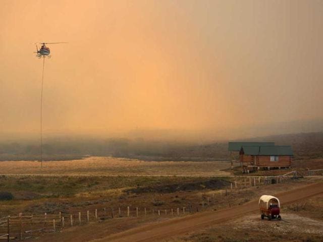 A firefighting helicopter fills a bucket of water in heavy smoke as the North Merna wildfire burns in the Bridger National Forest west of the town of Pinedale in Sublette County, Wyoming. Reuters photo