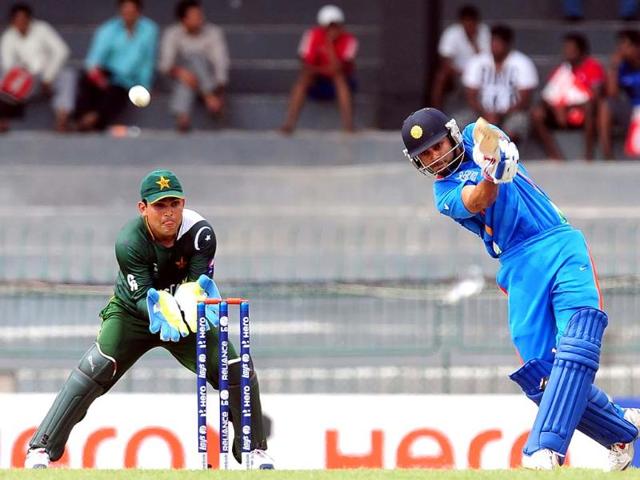 Virat Kohli is watched by Pakistani wicketkeeper Kamran Akmal as he plays a shot during a World Twenty20 warm-up match between India and Pakistan in Colombo. AFP/Lakruwan Wanniarachchi