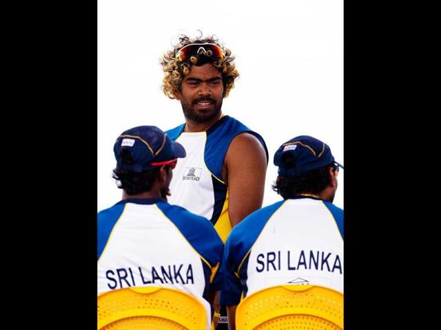 Sri Lanka's Lasith Malinga speaks to his teammates as they take a break during a practice session against Zimbabwe ahead of the World Twenty20 cricket match in Hambantota. AP Photo