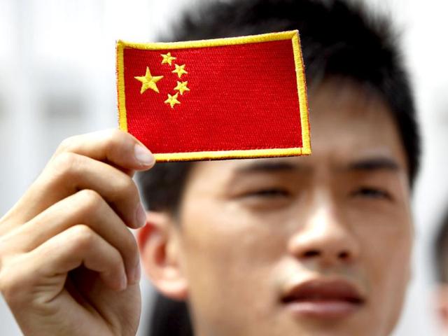 A Chinese protestor holds a Chinese national flag during an anti-Japan protest on disputed islands, called Senkaku in Japan and Diaoyu in China, outside the Japanese Embassy in Kuala Lumpur. AP Photo