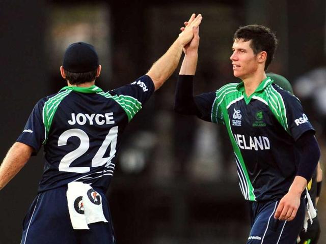 George Dockrell (R) celebrates with his teammate Nigel Jones (L) after dismissing Australia cricketer David Warner during the ICC Twenty20 Cricket World Cup match between Australia and Ireland at the R. Premadasa Stadium in Colombo. AFP Photo