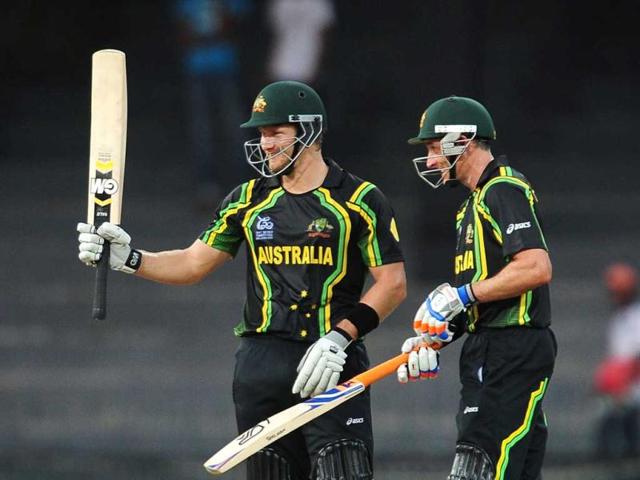 Shane Watson (L) is watched by his teammate Michael Hussey as he raises his bat to the crowd after scoring a half-century during the ICC Twenty20 Cricket World Cup match between Australia and Ireland at the R. Premadasa Stadium in Colombo. AFP Photo