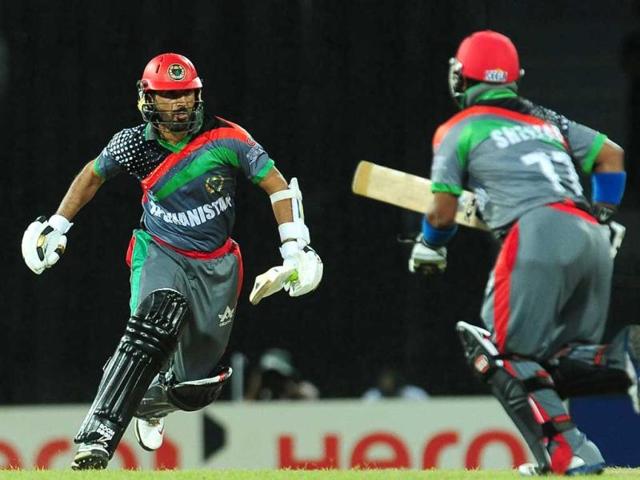 Afghanistan captain Nawroz Mangal (L) and teammate Mohammad Shahzad (R) run between the wickets during the ICC Twenty20 Cricket World Cup match between India and Afghanistan at the R Premadasa Stadium in Colombo. AFP/Lakruwan Wanniarachchi