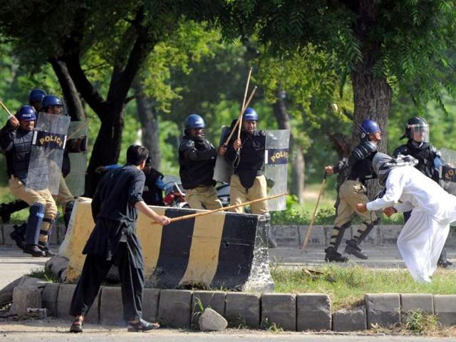 Pakistani riot police charge a demonstrator attempting to reach the US embassy during a protest against an anti-Islam film in Islamabad. AFP Photo/Aamir Qureshi