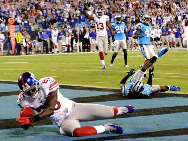 New York Giants wide receiver Martellus Bennett catches a touchdown pass past Carolina Panthers safety Charles Godfrey during the first quarter of an NFL football game in Charlotte, NC. AP/Mike McCarn
