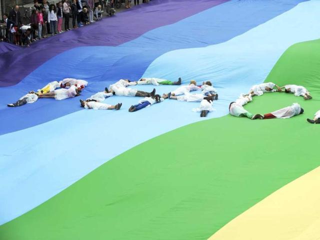 People lie on a peace flag, which has set a new world record with its size of 50m (164 ft) by 30m (98.4 ft), during the International Day of Peace in Ghent. Reuters photo