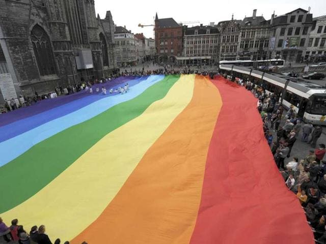 People gather around a peace flag that has set a new world record with its size of 50m (164 ft) by 30m (98.4 ft) during the International Day of Peace in Ghent. Reuters photo