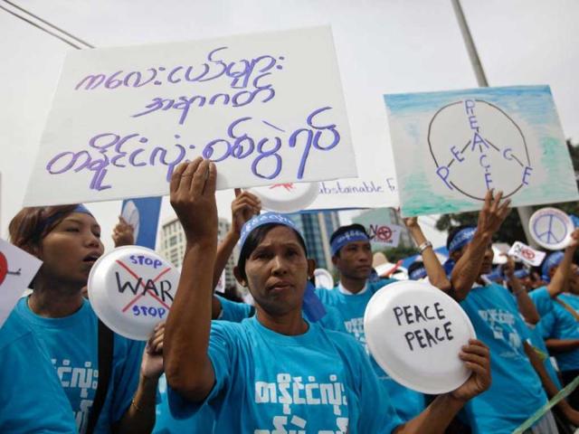 People hold posters during a march against civil war to mark the International Day of Peace in Yangon. Reuters photo