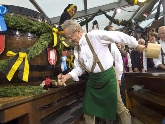 Mayor of Munich Christian Ude taps the first beer barrel during the official opening of the famous Bavarian "Oktoberfest" beer festival in Munich, southern Germany. (AP Photo/dapd, Joerg Koch)