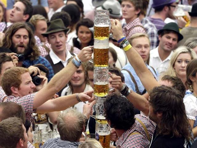 Young people celebrate the opening ceremony in the "Hofbraeuzelt' beer tent of the famous Bavarian "Oktoberfest" beer festival in Munich, southern Germany. (AP Photo/Matthias Schrader)
