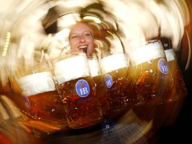 A waitress uses a whistle to free her way while carrying ten of the traditional one-litre 'Masskrug' beer mugs at the opening day of the Munich Oktoberfest at the Theresienwiese in Munich. The world's biggest beer festival runs until October 7. REUTERS/Kai Pfaffenbach