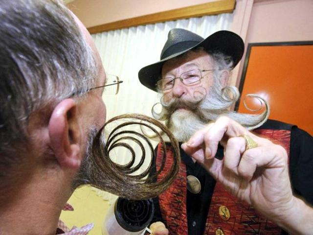 Competitors get prepared prior to go on stage during the first edition of the European Beard and Moustache championships in Wittersdorf, eastern France. (AFP photo/Sebastein Bozon)