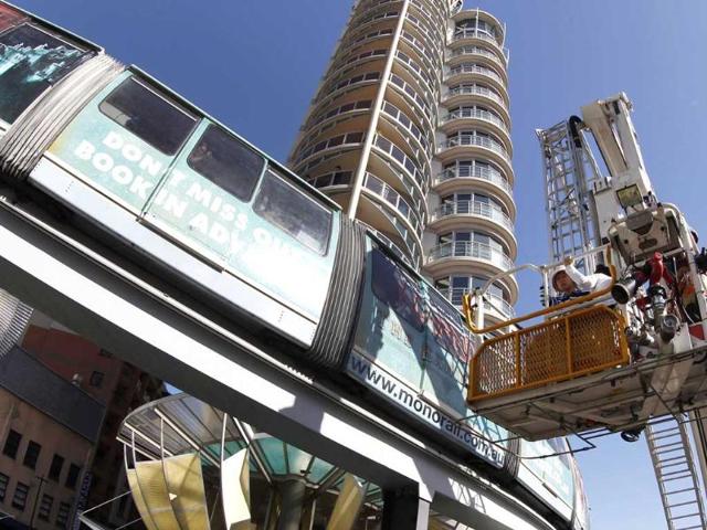 A boy is rescued from the Monorail after it stopped between stations in central Sydney. Twenty-eight passengers, most of them international tourists, were trapped on the monorail after it stopped between stations. Reuters/Daniel Munoz